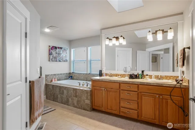 a spacious bathroom with a double vanity sink mirror and double