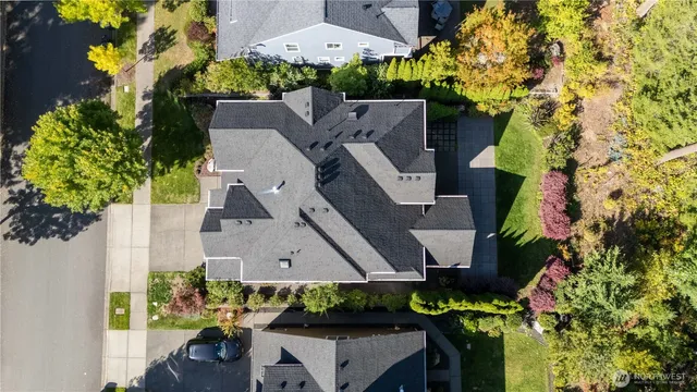 an aerial view of a house with a yard swimming pool and outdoor seating