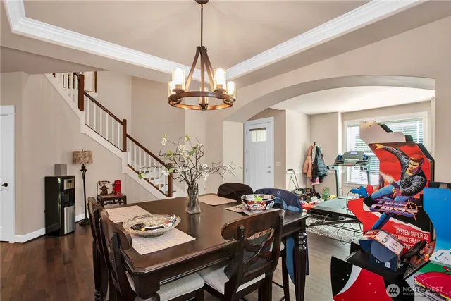 a view of a livingroom with furniture wooden floor and a chandelier
