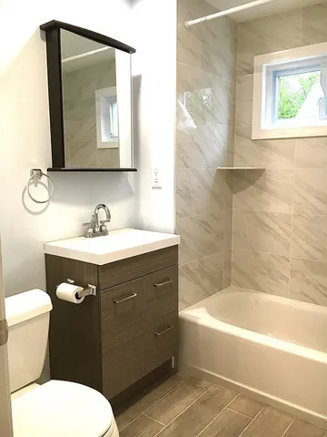a bathroom with a sink toilet and tub