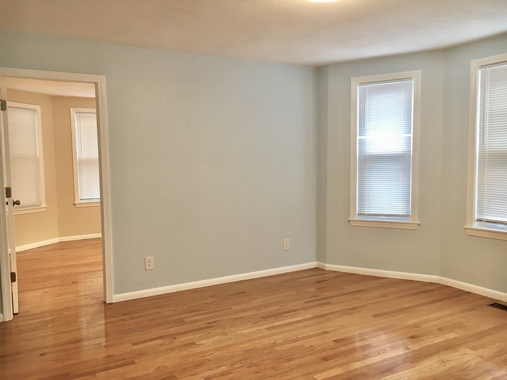 31 Wellington Road Medford, MA 02155 - Photo 6 of 11 a view of empty room with wooden floor and fan