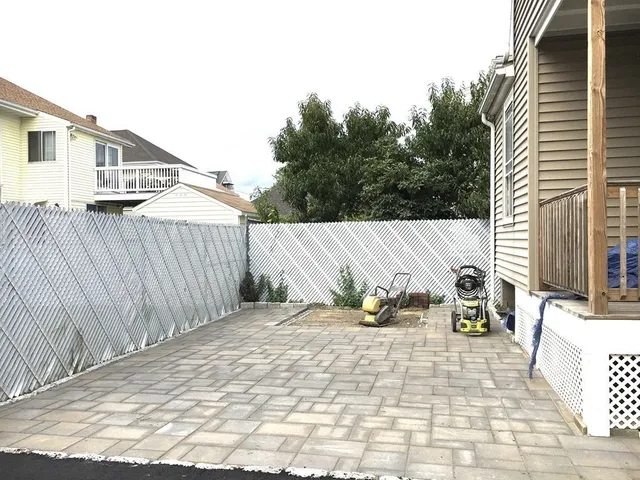 a backyard of a house with table and chairs