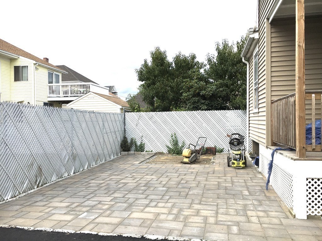 31 Wellington Road Medford, MA 02155 - Photo 9 of 11 a backyard of a house with table and chairs