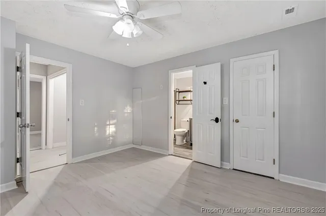 an empty room with fan and entrance