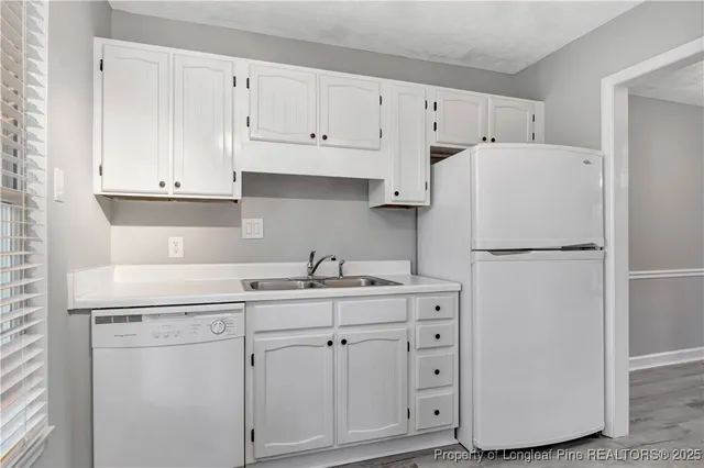 a kitchen with appliances cabinets and a sink