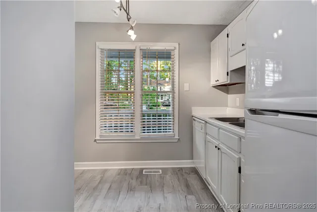 a kitchen with granite countertop a stove and a wooden floor