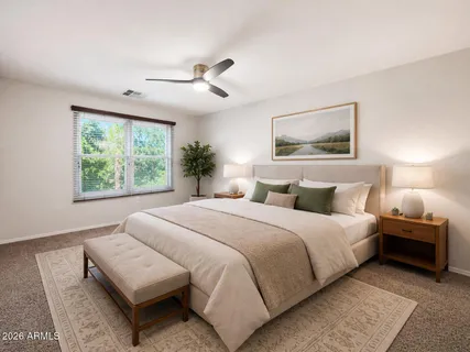 a bedroom with a large bed and a window