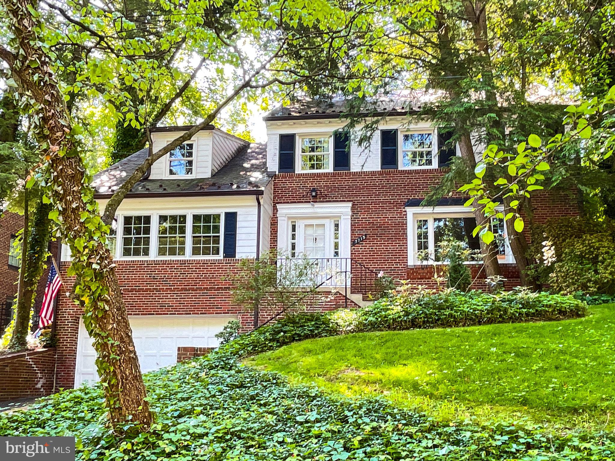 7215 Rollingwood Drive Chevy Chase, MD 20815 - Photo 1 of 42 front view of a house with a yard