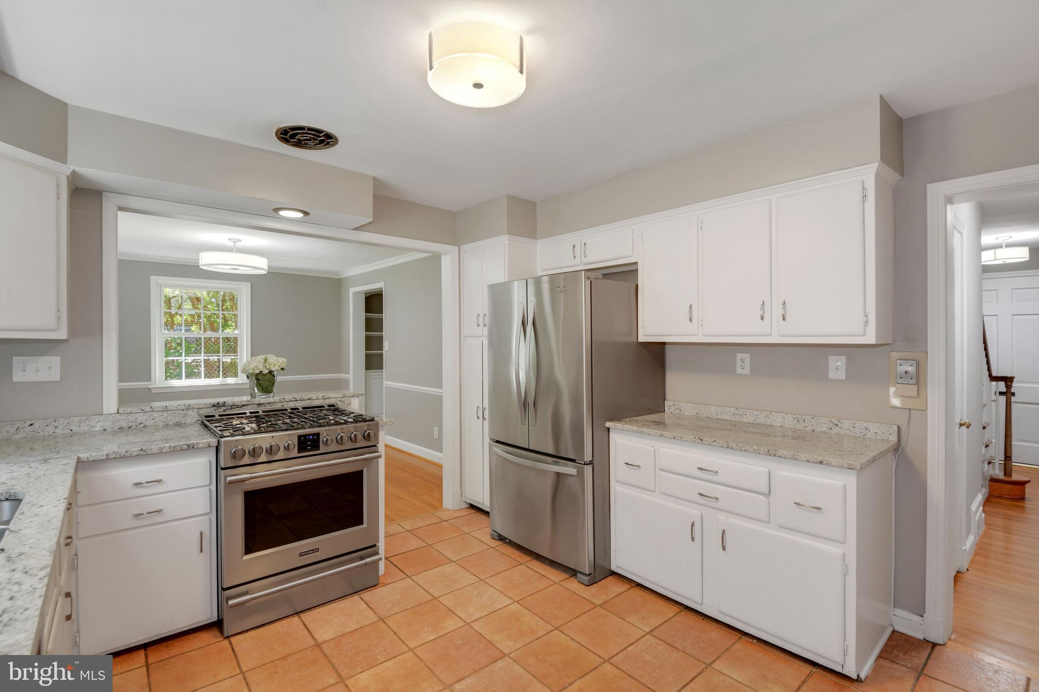 7215 Rollingwood Drive Chevy Chase, MD 20815 - Photo 14 of 42 a kitchen with cabinets stainless steel appliances and a window