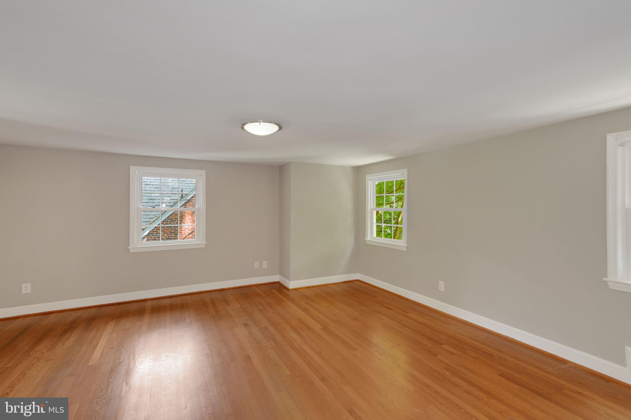 7215 Rollingwood Drive Chevy Chase, MD 20815 - Photo 21 of 42 a view of empty room with wooden floor and fan