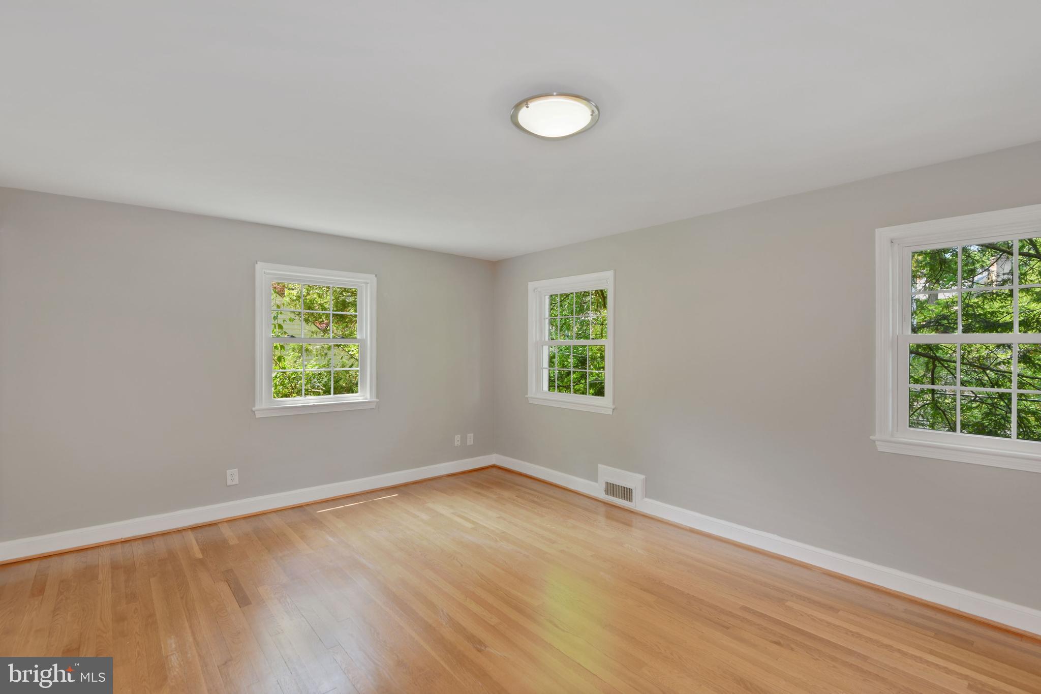 7215 Rollingwood Drive Chevy Chase, MD 20815 - Photo 28 of 42 a view of an empty room with wooden floor and a window