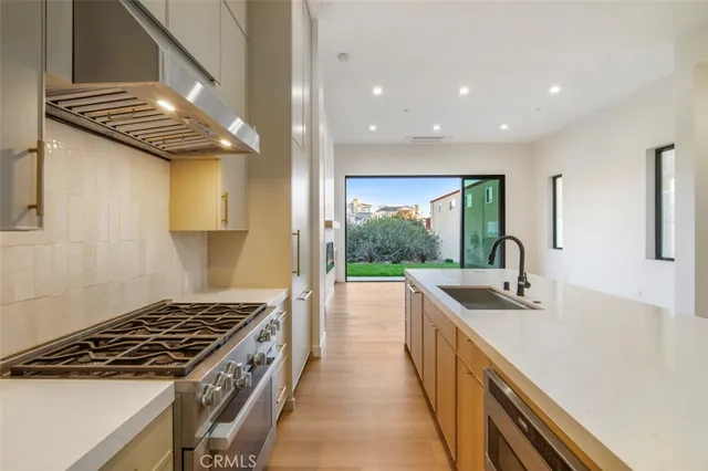 a kitchen with sink stove and cabinets