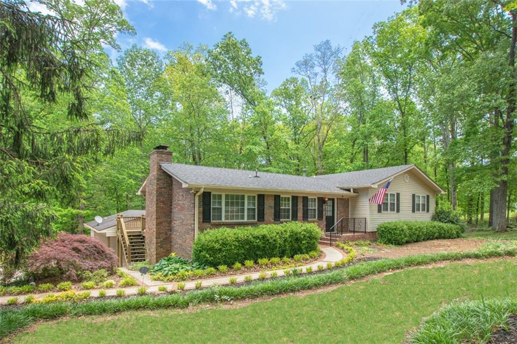 Beautiful Ranch with basement on 4 acres with acreage, barn with three stalls, pasture, huge detached garage/workshop, outdoor chefs kitchen and trails.