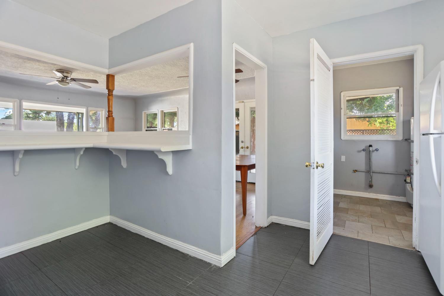 916 Elm Avenue Modesto, CA 95351 - Photo 18 of 52 19. Kitchen/laundry access area This back-of-house area adds useful utility space right off the kitchen — the kind of practical feature buyers appreciate once they start picturing daily life.