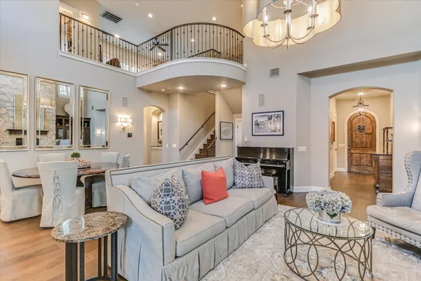 a living room with furniture chandelier and a view of living room