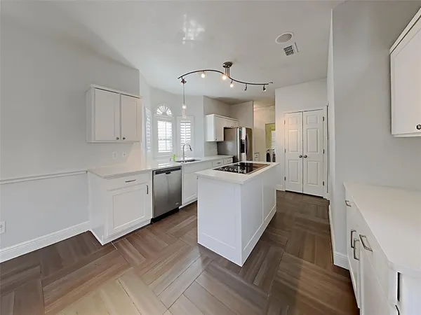 a kitchen with cabinets a sink and a stove top oven