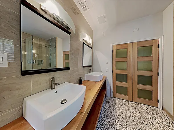 a bathroom with a tub sink and mirror