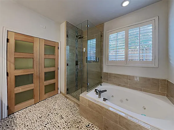 a bathroom with a bathtub and a shower
