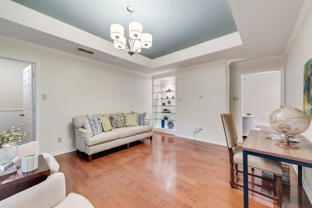 907 Sunpoint Circle Rockwall, TX 75087 - Photo 12 of 37 a living room with furniture and a chandelier
