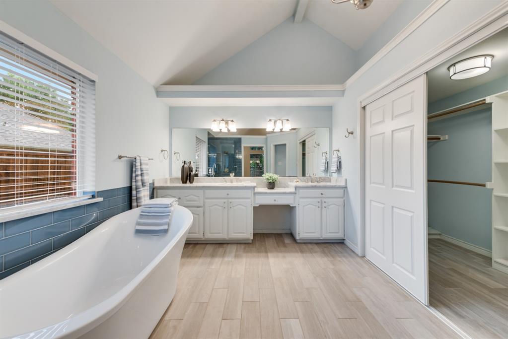 907 Sunpoint Circle Rockwall, TX 75087 - Photo 20 of 37 a large white kitchen with a lot of counter space and a wooden floor