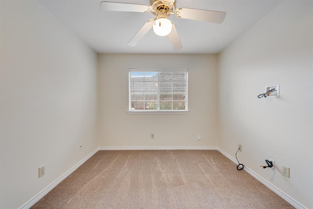 907 Sunpoint Circle Rockwall, TX 75087 - Photo 24 of 37 an empty room with a window and a fan