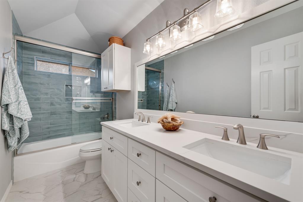 907 Sunpoint Circle Rockwall, TX 75087 - Photo 26 of 37 a bathroom with a sink double vanity and a shower