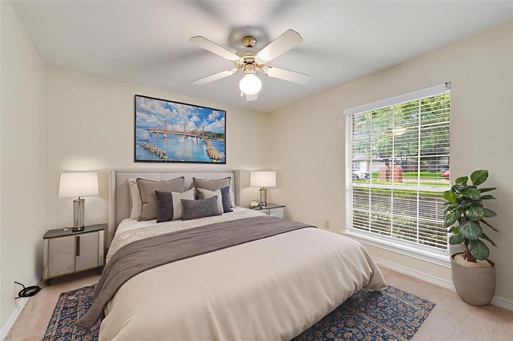 907 Sunpoint Circle Rockwall, TX 75087 - Photo 31 of 37 a bedroom with a large bed and a potted plant