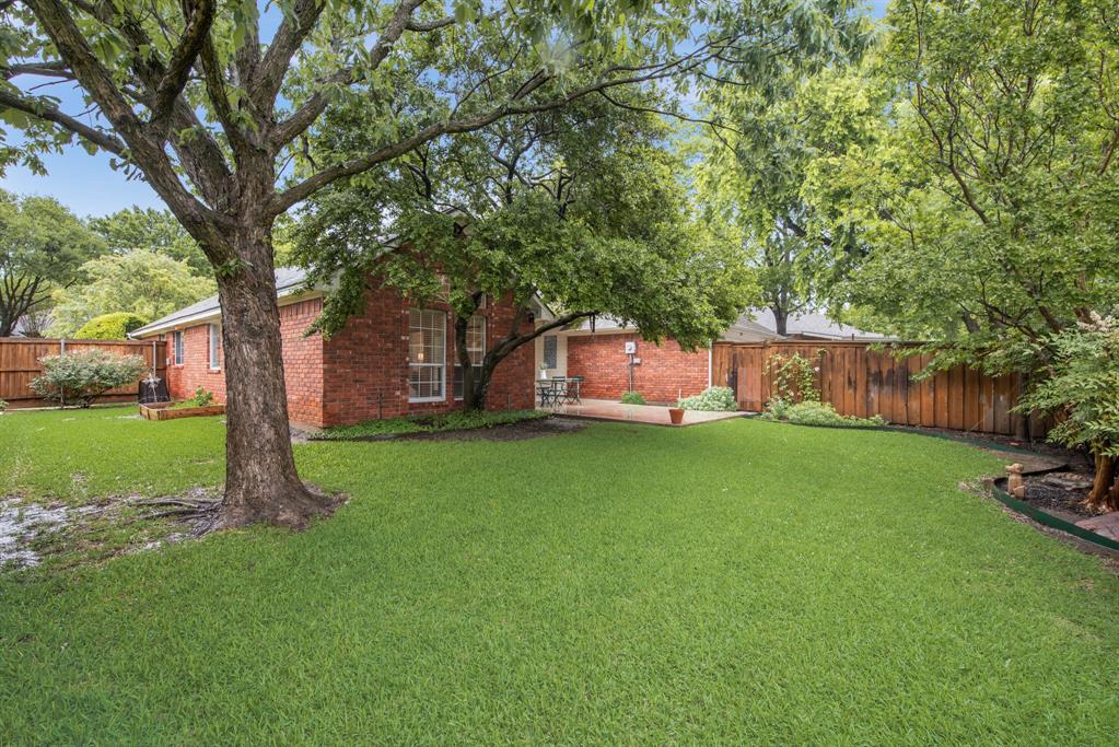 907 Sunpoint Circle Rockwall, TX 75087 - Photo 36 of 37 a view of a garden with a tree