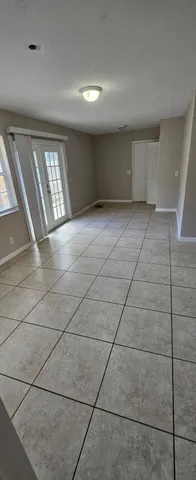 a view of a livingroom with wooden floor and a window