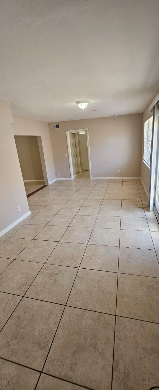 1202 Summer Street, Unit 1202 Palm Springs, FL 33461 - Photo 15 of 32 a view of a livingroom with wooden floor and a window