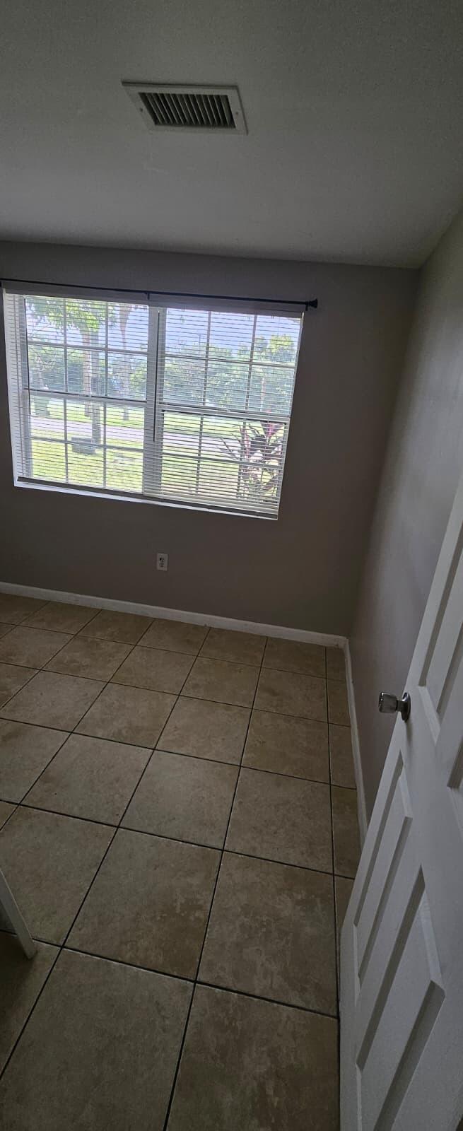 1202 Summer Street, Unit 1202 Palm Springs, FL 33461 - Photo 22 of 32 a view of an empty room with a window