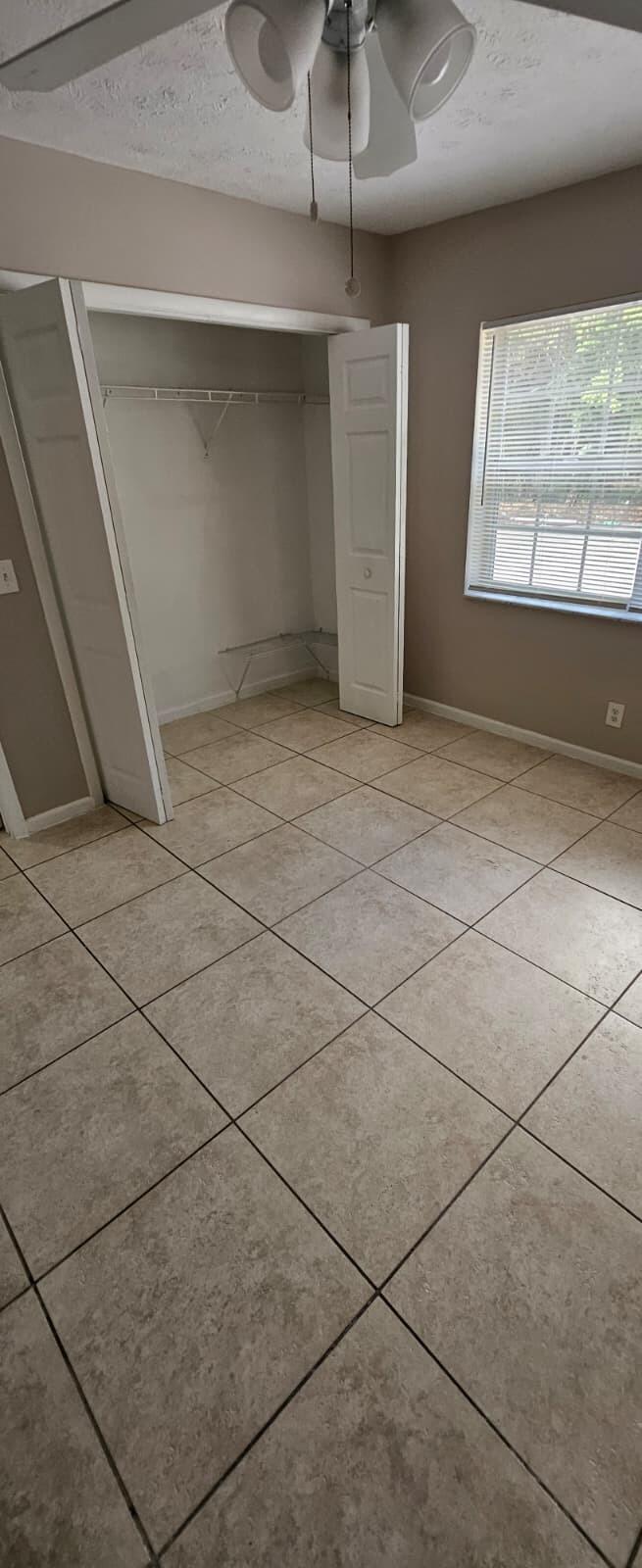 1202 Summer Street, Unit 1202 Palm Springs, FL 33461 - Photo 9 of 32 an empty room with windows