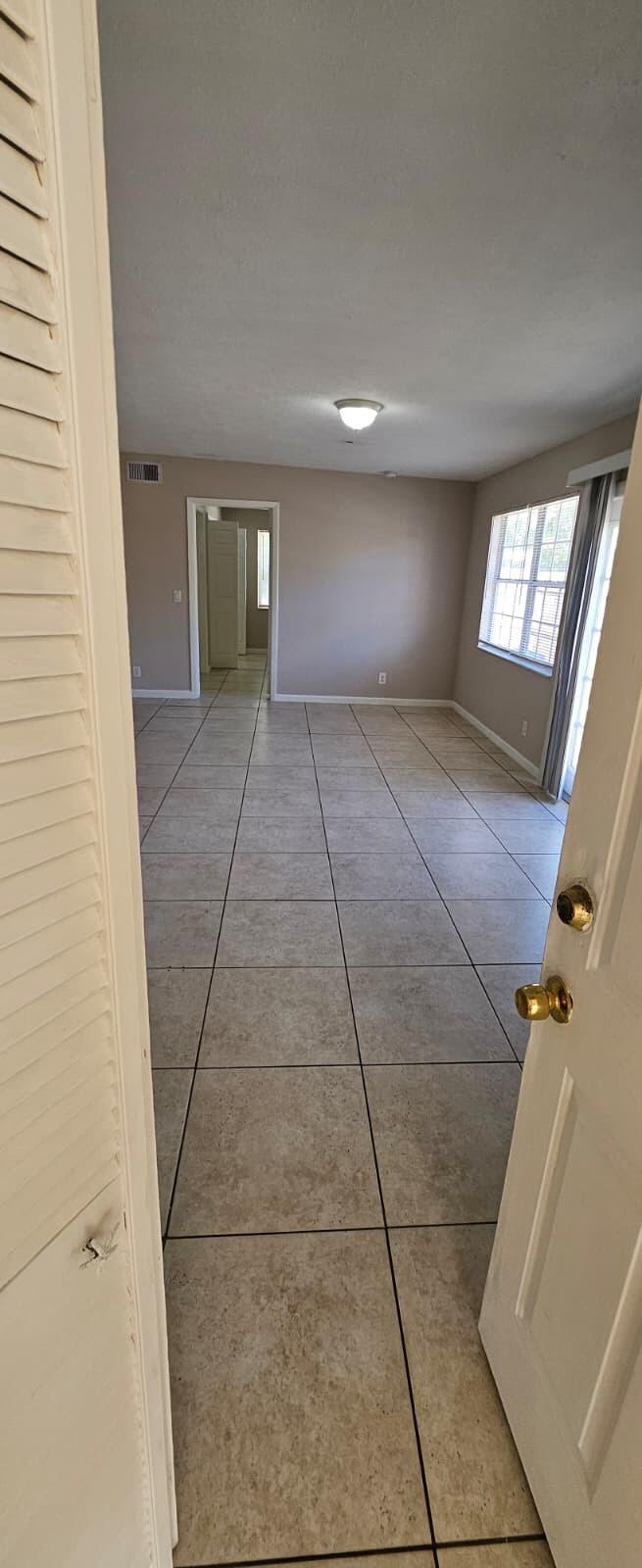 1202 Summer Street, Unit 1202 Palm Springs, FL 33461 - Photo 10 of 32 a view of a hallway with windows