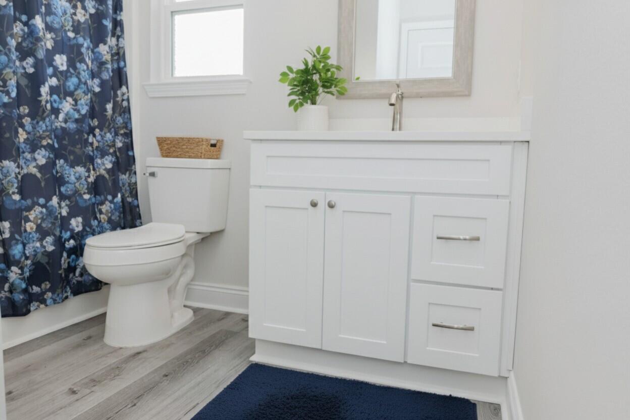 5352 Highview Drive Crestview, FL 32539 - Photo 11 of 32 a bathroom with a sink a toilet and mirror