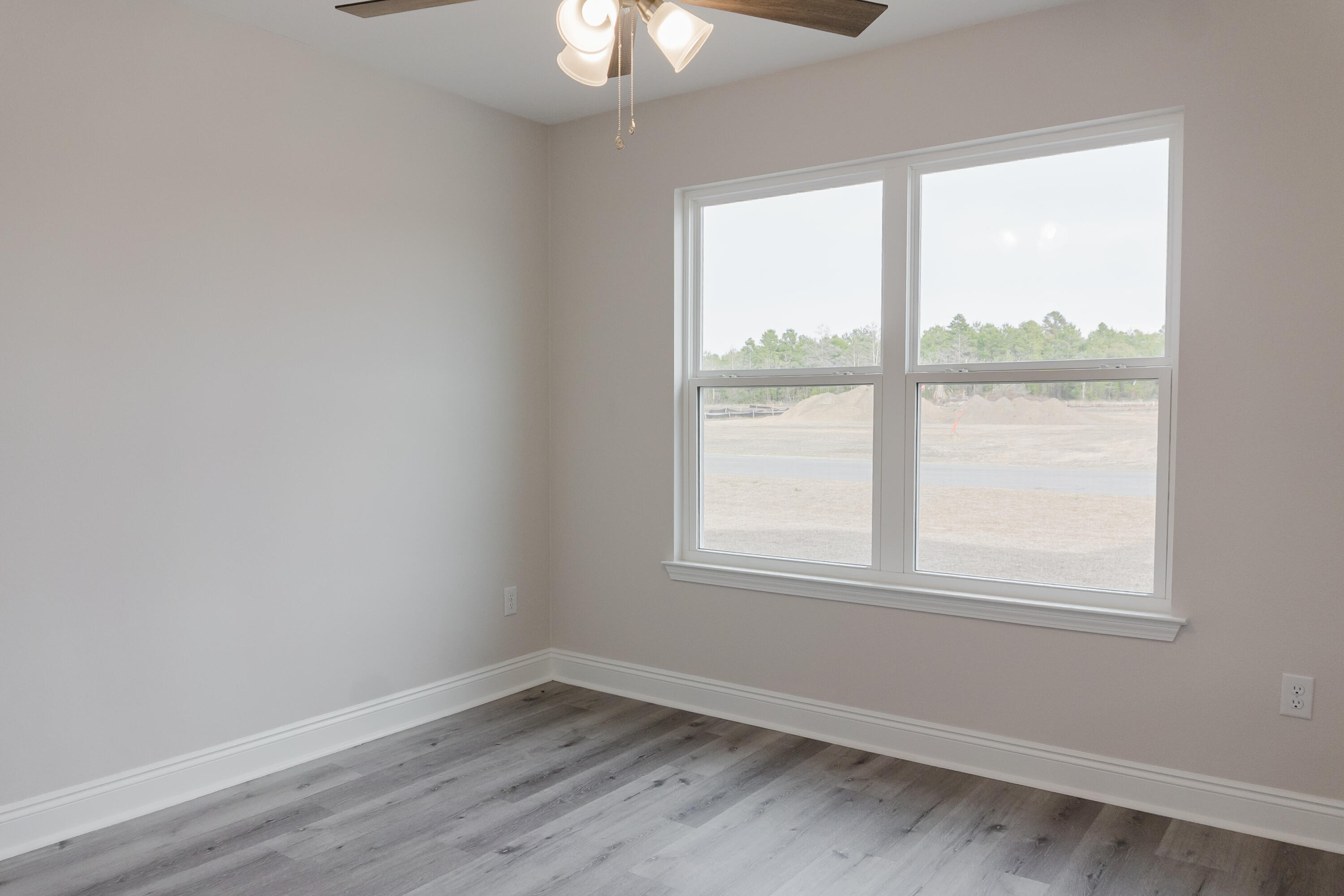 5352 Highview Drive Crestview, FL 32539 - Photo 12 of 32 an empty room with wooden floor and windows