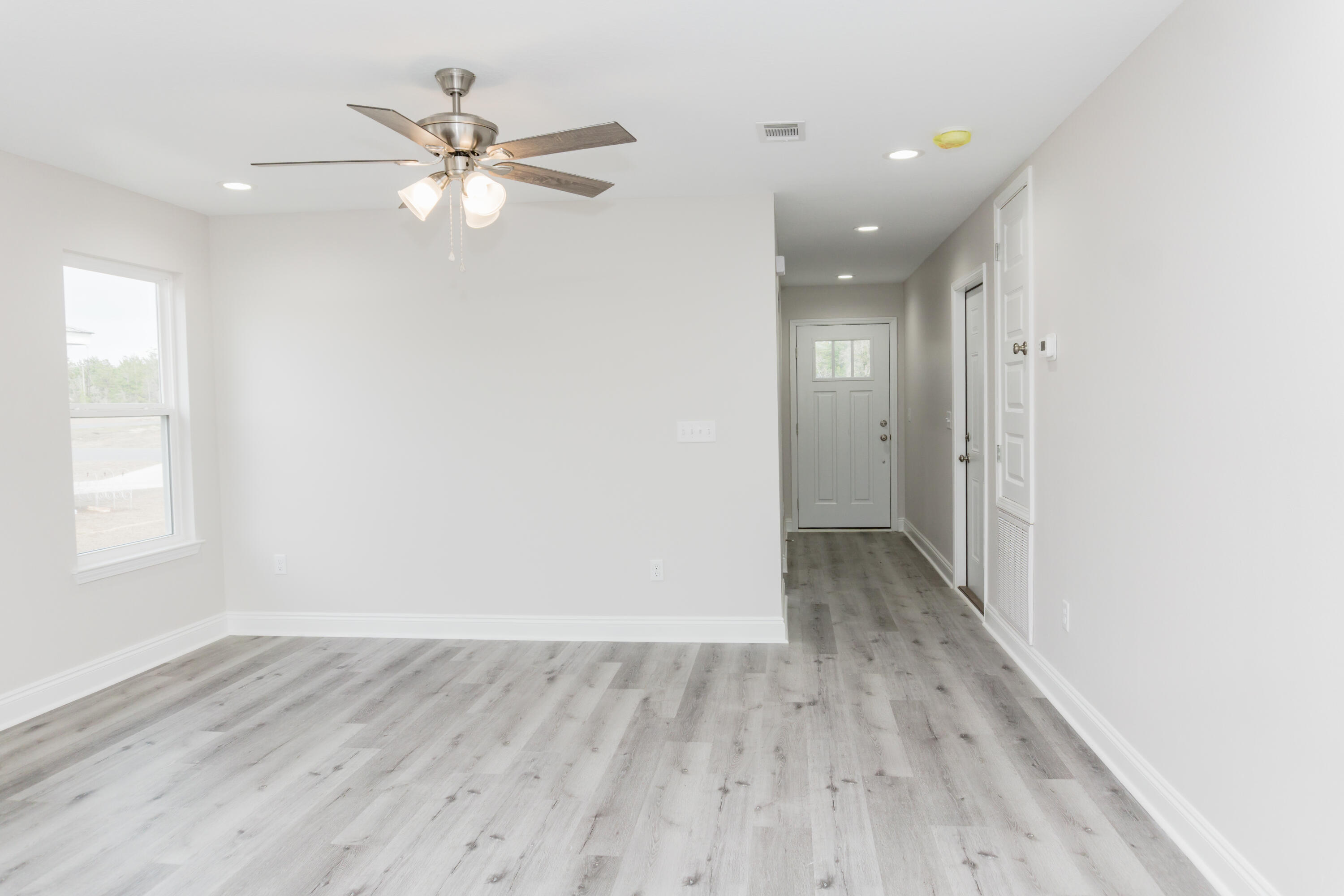 5352 Highview Drive Crestview, FL 32539 - Photo 18 of 32 wooden floor in an empty room with a window