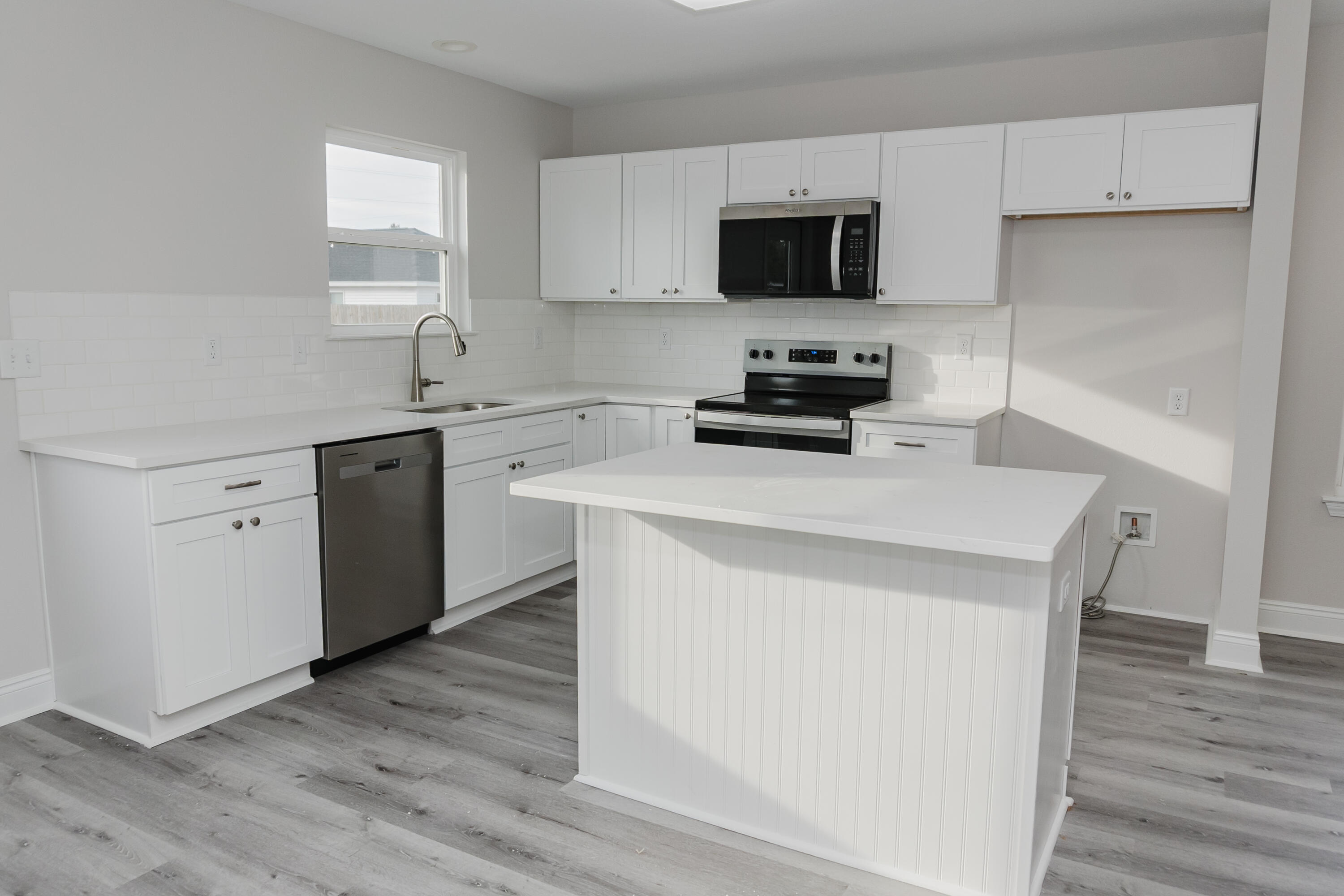 5352 Highview Drive Crestview, FL 32539 - Photo 19 of 32 a kitchen with a sink cabinets and wooden floor