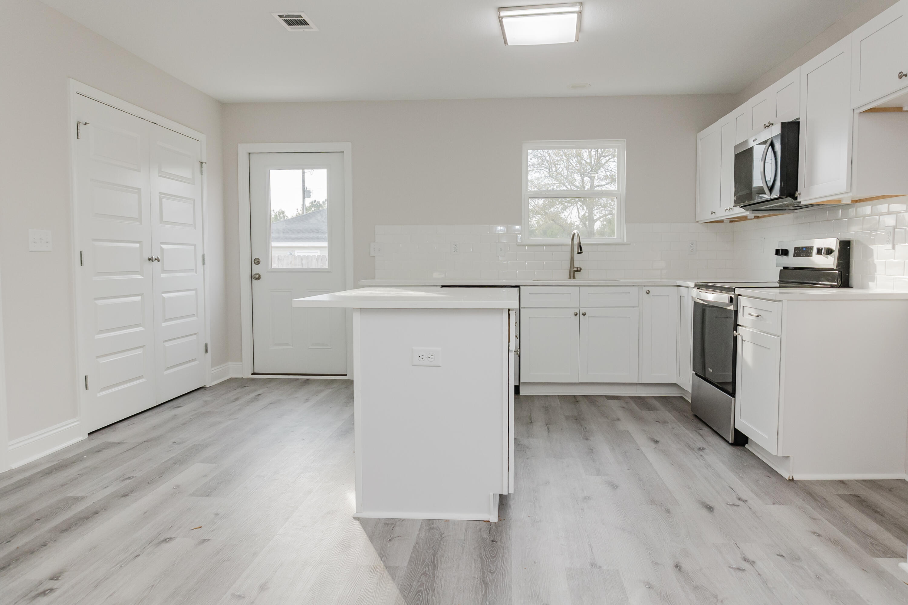 5352 Highview Drive Crestview, FL 32539 - Photo 22 of 32 an empty room with wooden floor and window