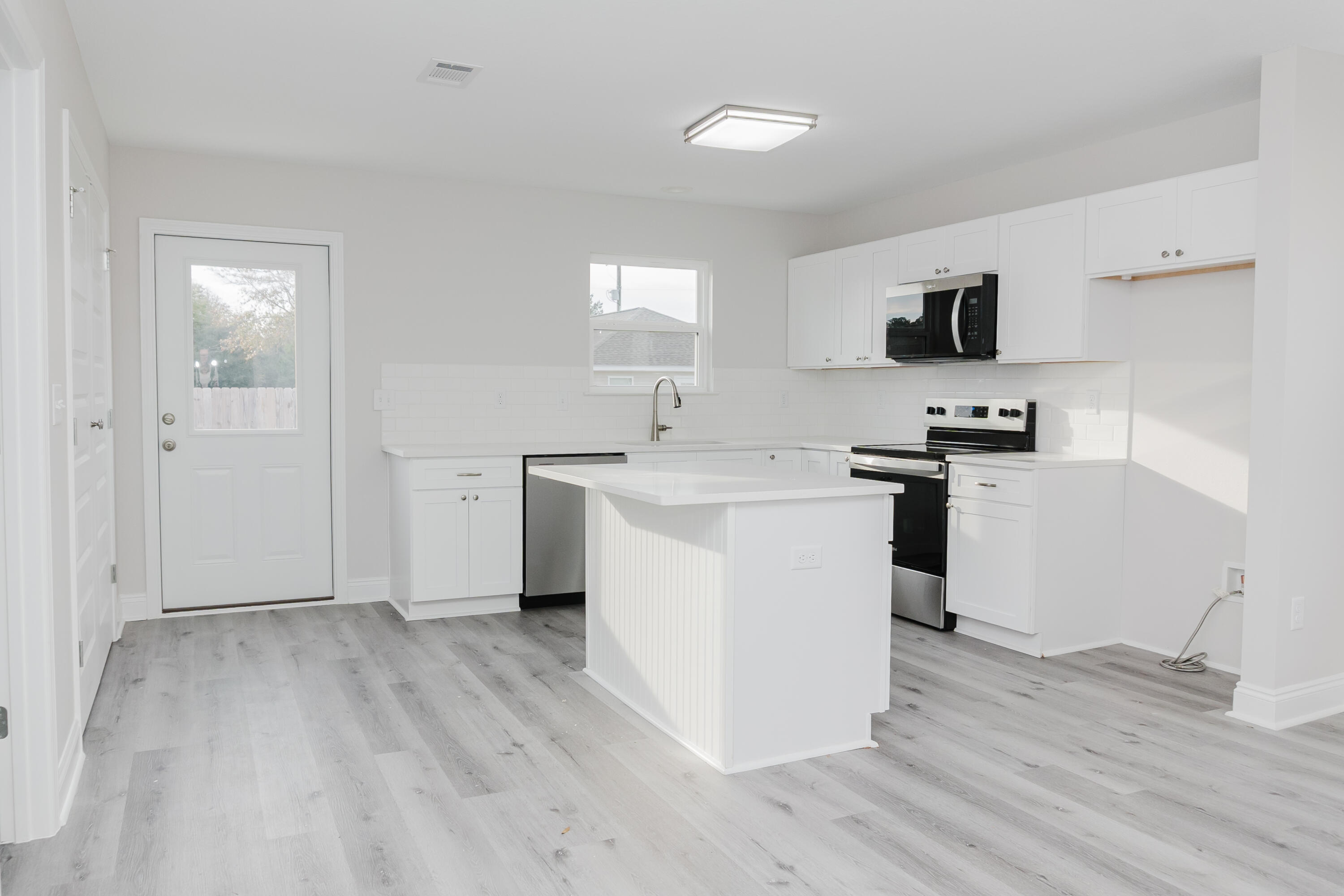 5352 Highview Drive Crestview, FL 32539 - Photo 24 of 32 a kitchen with a sink cabinets and wooden floor