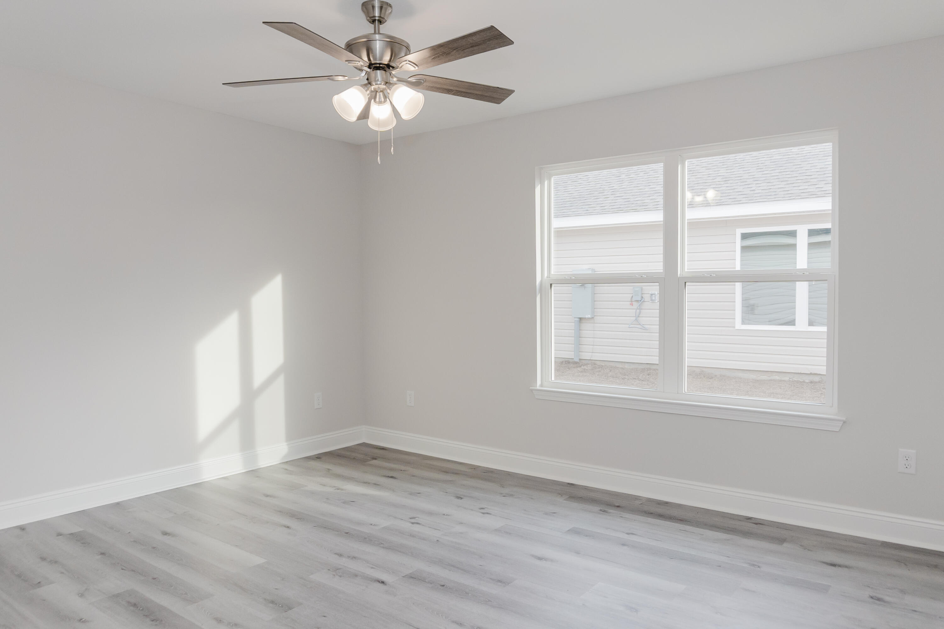 5352 Highview Drive Crestview, FL 32539 - Photo 27 of 32 wooden floor in an empty room with a window