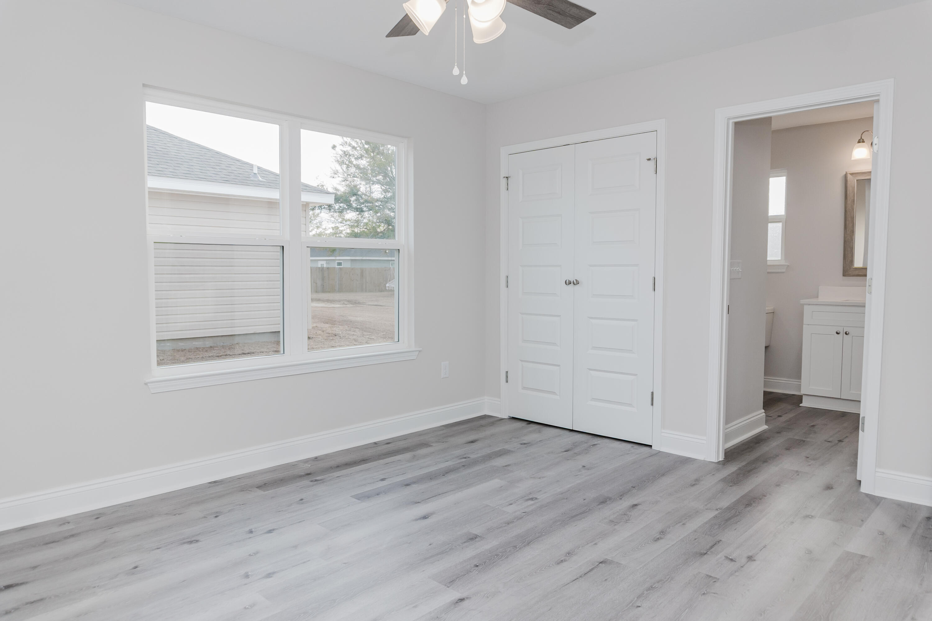 5352 Highview Drive Crestview, FL 32539 - Photo 29 of 32 a view of an empty room with wooden floor and a window