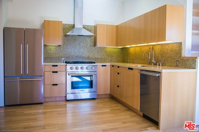 a kitchen with stainless steel appliances a stove and a refrigerator