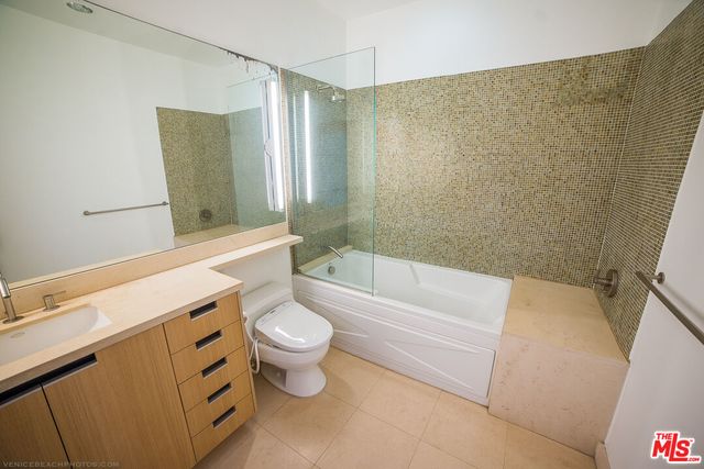 a bathroom with a sink a toilet and bathtub
