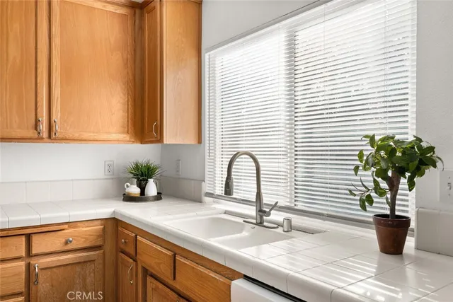 a kitchen with granite countertop cabinets and stainless steel appliances