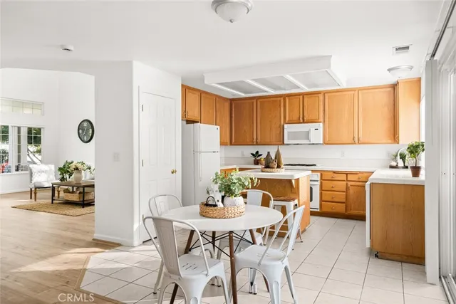 a kitchen with a window a sink and potted plant
