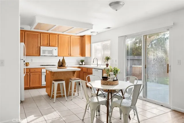 a dining room filled a chandelier a glass table and chairs