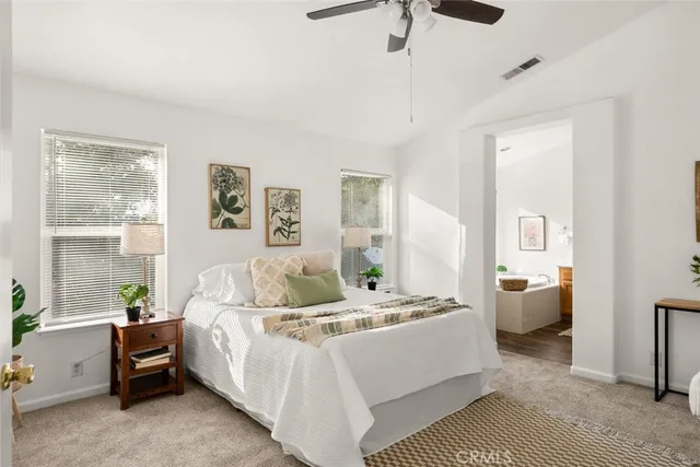 a kitchen with a dining table chairs and white cabinets