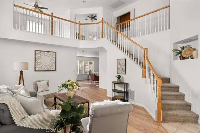 a living room with furniture or stairs and a wooden floor