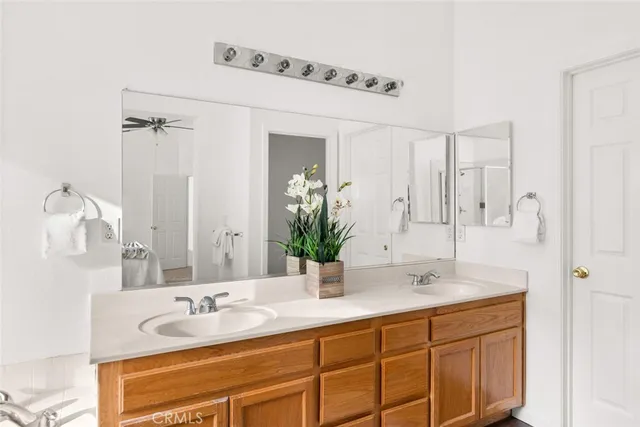 a bathroom with a granite countertop sink and a window
