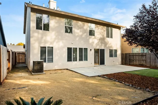 a view of backyard with wooden fence